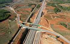 Aerial view of the railway section, you can see how a road is located above the section with the surrounding scrubland landscape